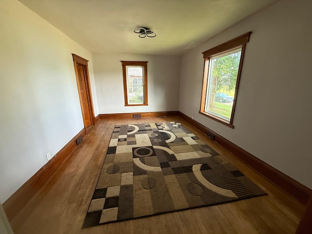 902 Pacific Ave, Kerkhoven, MN 56252 - unfurnished room featuring wood finished floors and healthy amount of natural light