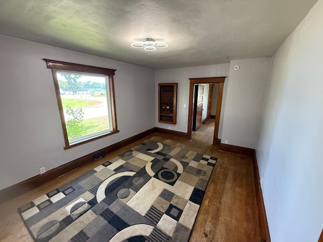 902 Pacific Ave, Kerkhoven, MN 56252 - unfurnished room with wood finished floors