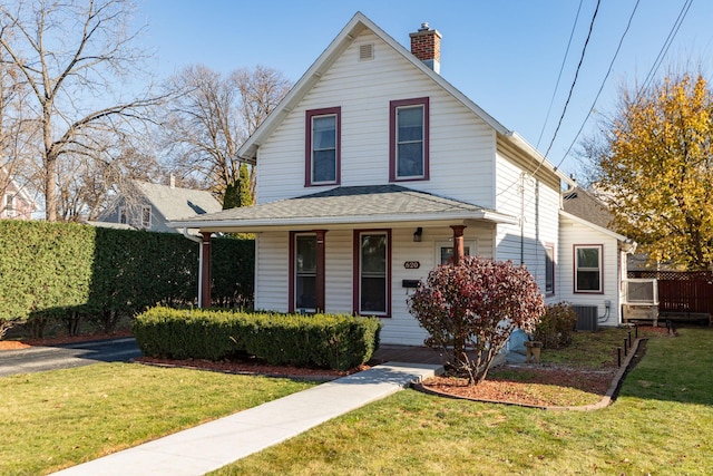 view of front of property featuring central air condition unit, a chimney, roof with shingles, and a front yard