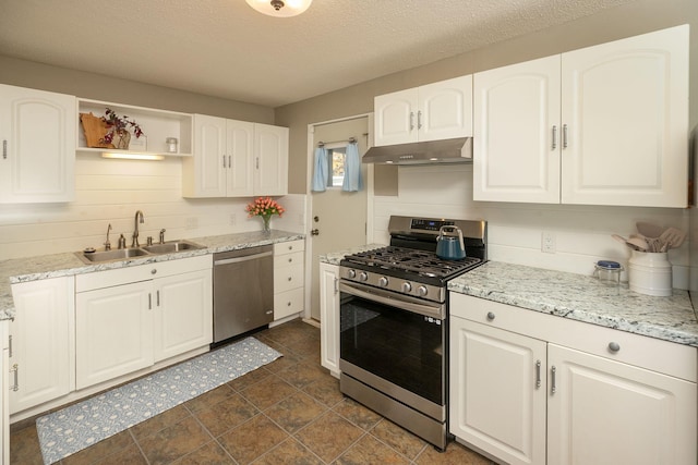 kitchen with under cabinet range hood, open shelves, a sink, appliances with stainless steel finishes, and white cabinets