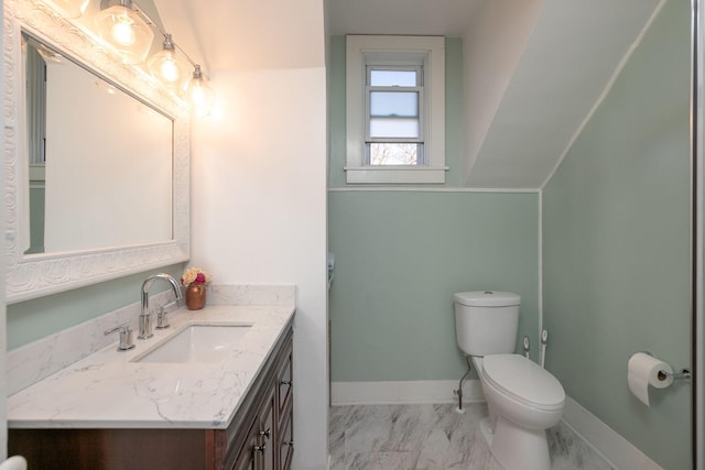 bathroom featuring marble finish floor, toilet, vanity, and baseboards