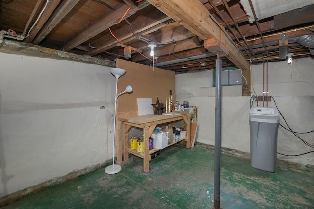 unfinished basement featuring a workshop area