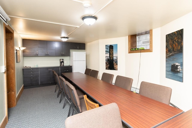 dining room featuring carpet floors and baseboard heating