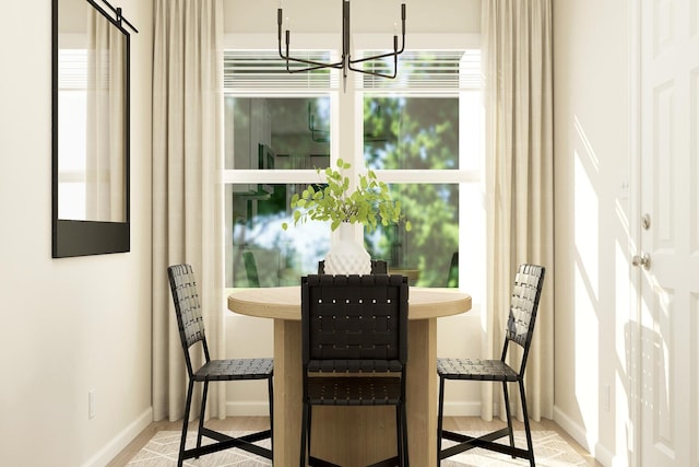 dining room with baseboards and a chandelier