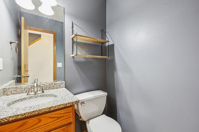 bathroom featuring toilet and vanity