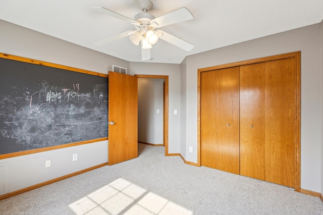 unfurnished bedroom with a closet, baseboards, carpet, and visible vents