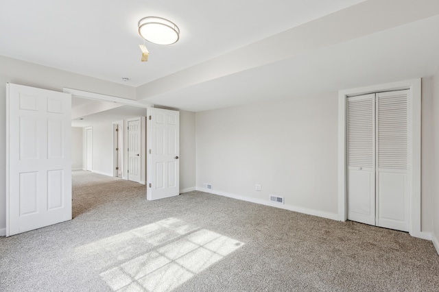 unfurnished bedroom featuring a closet, visible vents, baseboards, and carpet