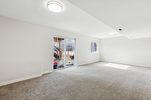 carpeted empty room featuring visible vents and baseboards