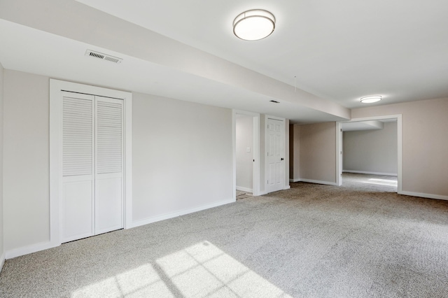 finished basement featuring visible vents, baseboards, and carpet