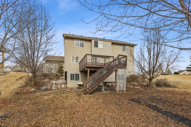 rear view of house featuring stairway and a wooden deck