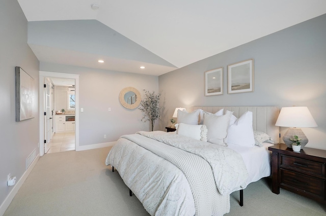 bedroom with baseboards, lofted ceiling, recessed lighting, ensuite bathroom, and light carpet