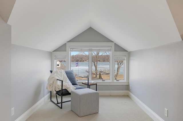 sitting room with baseboards, lofted ceiling, and carpet flooring