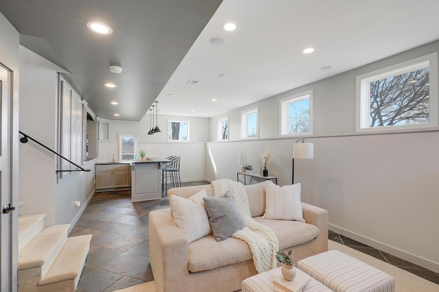 living area featuring plenty of natural light, recessed lighting, stairway, and baseboards