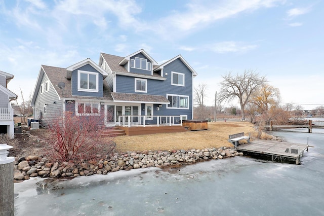 view of front of property with a deck and a shingled roof