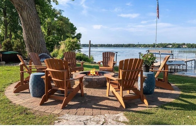 exterior space featuring a water view, a dock, and an outdoor fire pit