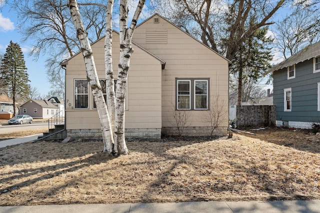 view of front of home featuring fence