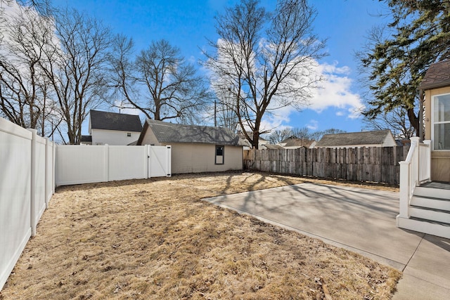 view of yard with a patio area, a gate, and a fenced backyard