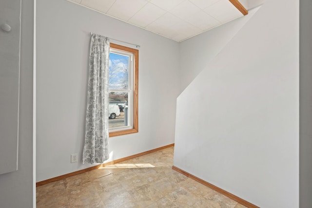 unfurnished room featuring baseboards