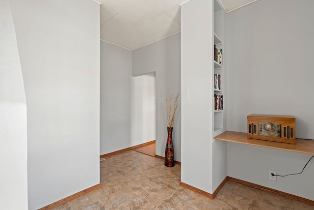 interior space with baseboards and stone finish flooring