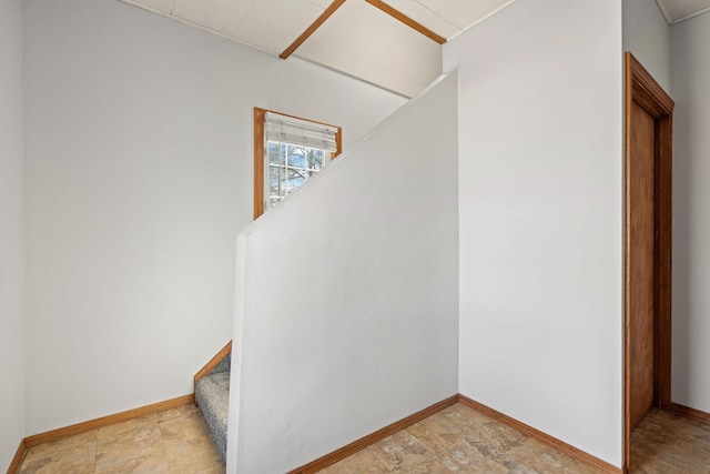 stairway featuring baseboards