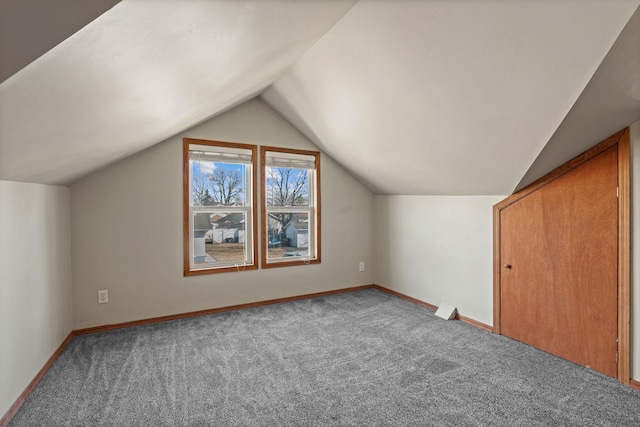 bonus room with carpet flooring, baseboards, and vaulted ceiling