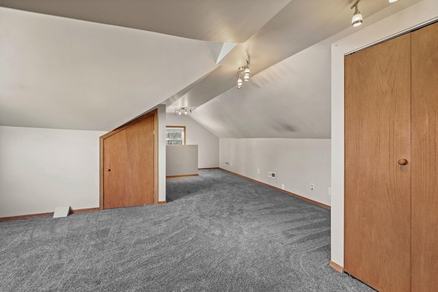 bonus room featuring lofted ceiling, carpet, baseboards, and visible vents