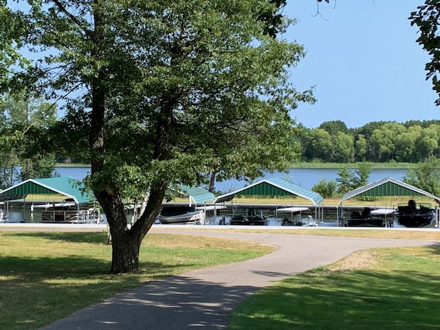 surrounding community featuring a yard and a water view