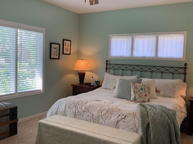 carpeted bedroom featuring baseboards