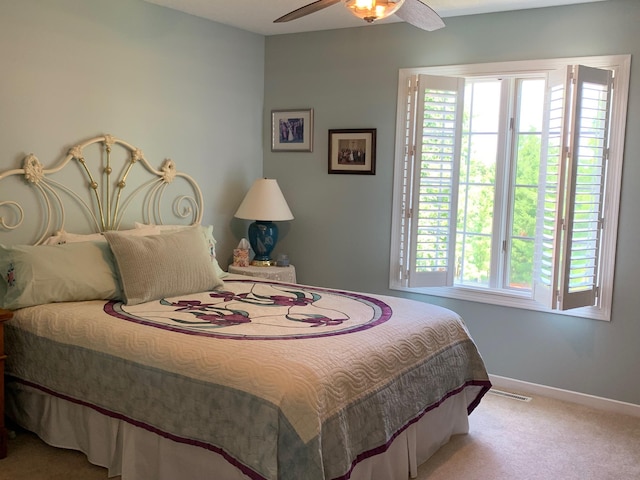 bedroom with carpet flooring, visible vents, baseboards, and ceiling fan