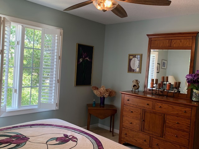 bedroom featuring baseboards and a ceiling fan