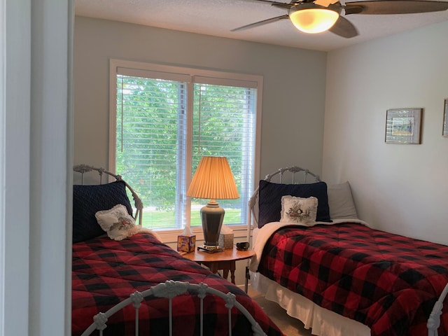 bedroom featuring multiple windows and a ceiling fan