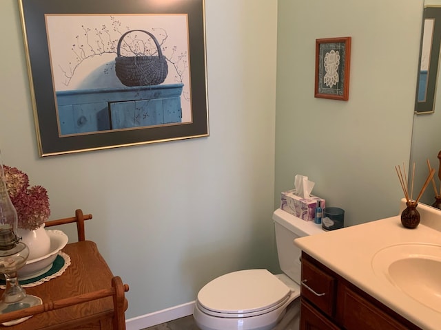 half bath featuring toilet and vanity