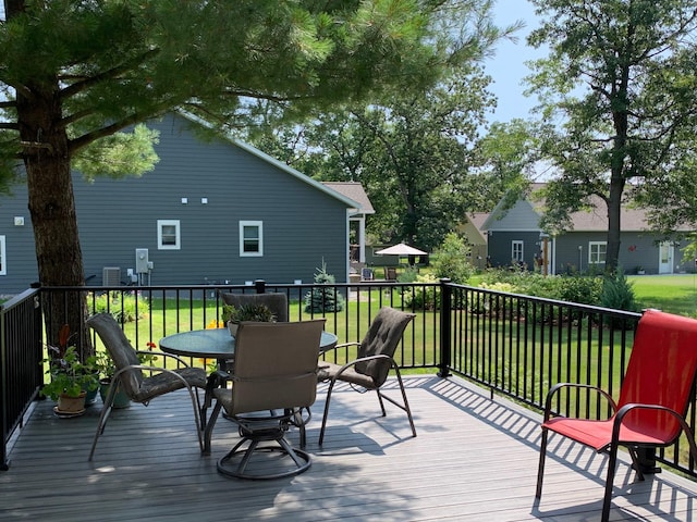 deck featuring a yard and outdoor dining area