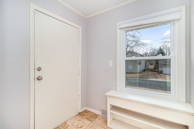 interior space featuring light tile patterned flooring, visible vents, crown molding, and baseboards