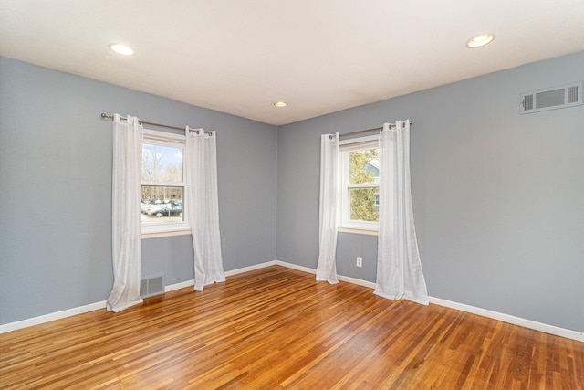 unfurnished room with recessed lighting, visible vents, baseboards, and light wood-style flooring