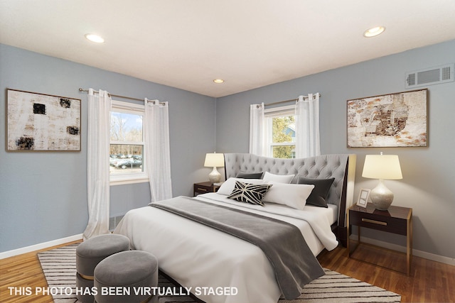 bedroom featuring visible vents, recessed lighting, baseboards, and wood finished floors