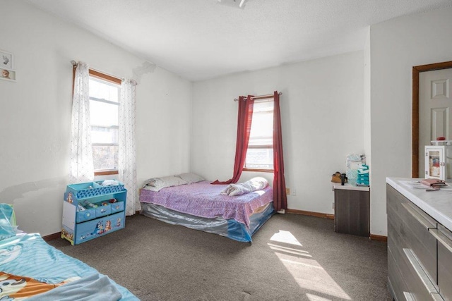 carpeted bedroom featuring baseboards