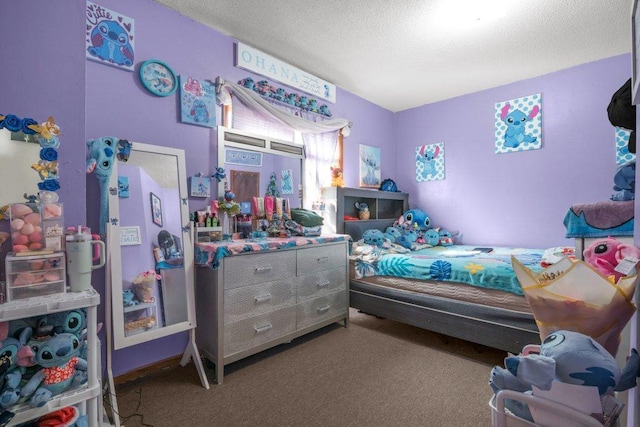 bedroom with a textured ceiling and carpet floors