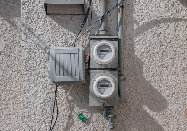 exterior details with electric meter and stucco siding