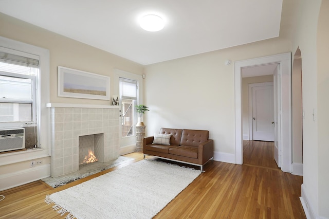 2606 Humboldt Ave S Unit 6, Minneapolis, MN 55408 - living area featuring a tiled fireplace, wood finished floors, and plenty of natural light