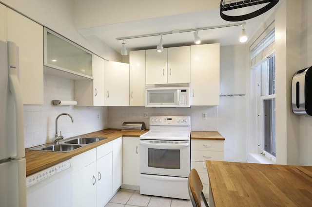2606 Humboldt Ave S Unit 6, Minneapolis, MN 55408 - kitchen with wooden counters, white appliances, a sink, rail lighting, and decorative backsplash