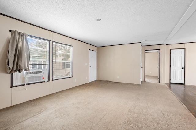 carpeted empty room featuring a textured ceiling