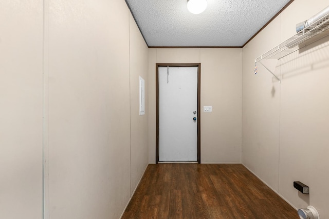 interior space featuring a textured ceiling, crown molding, and wood finished floors