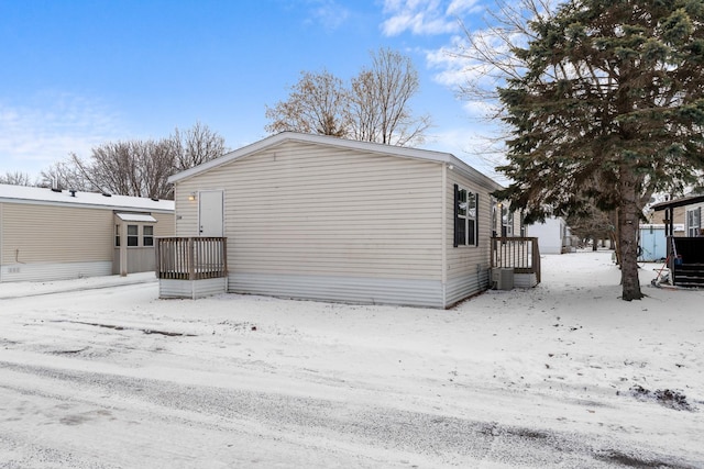 view of snow covered back of property