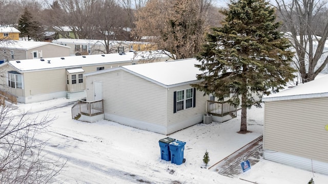 view of snow covered back of property