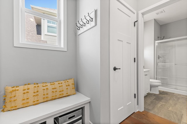 mudroom with visible vents and dark wood-style floors