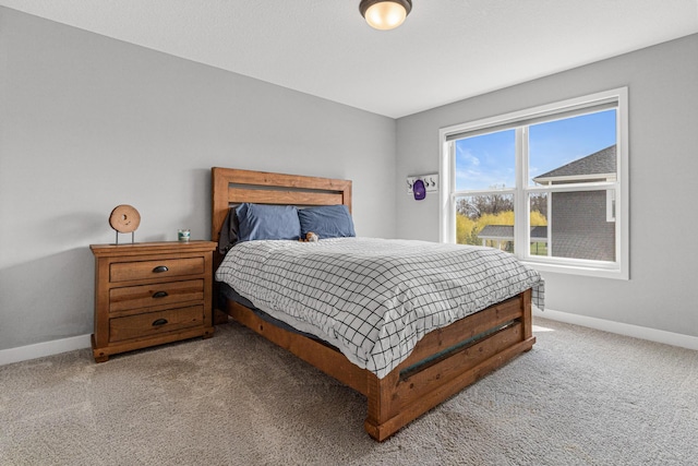 carpeted bedroom with baseboards