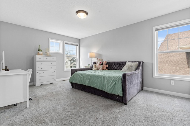 carpeted bedroom featuring baseboards