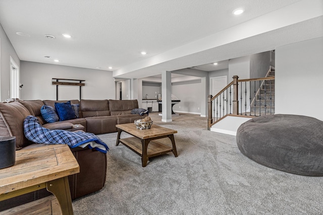 carpeted living area with stairway and recessed lighting