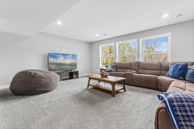 carpeted living room with baseboards, recessed lighting, and a textured ceiling